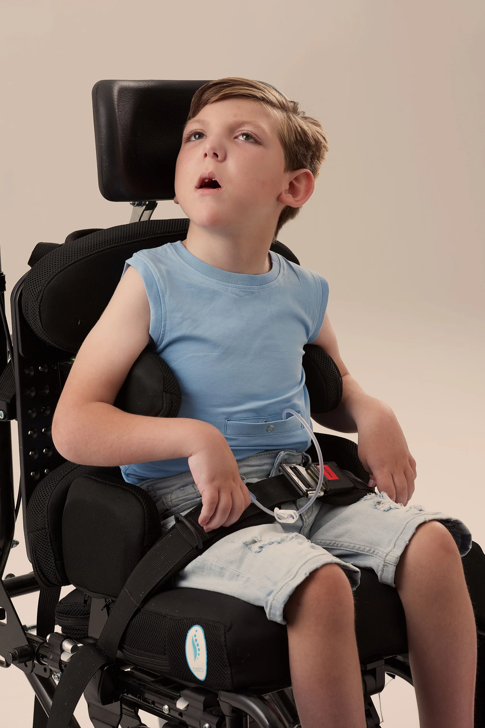 A boy wears blue KayCey Popper Vest - Sleeveless with Tube Access